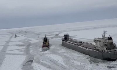 After being released from the ice on frozen Lake Erie, a freighter is seen moving
